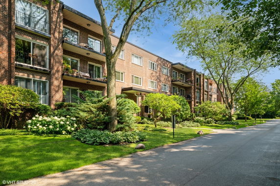Front view of a multi-story brick building with balconies.