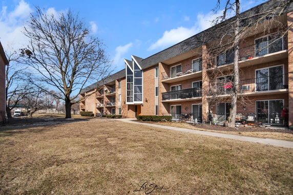 Front view of a multi-story residential building with balconies.