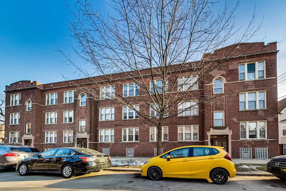 Front view of a multi-story brick apartment building.