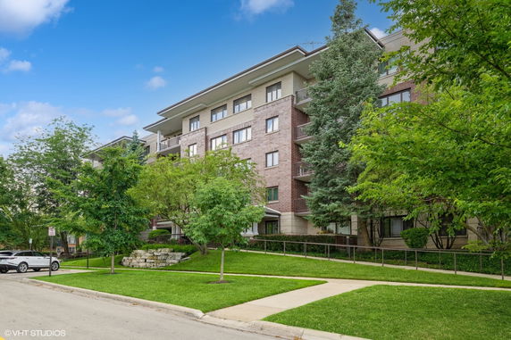 Front view of a multi-story apartment building with balconies.