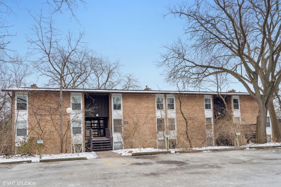Front view of a two-story brick apartment building.