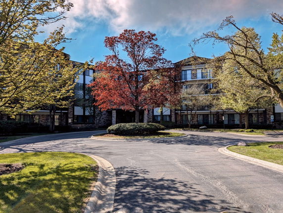 Front view of a multi-story building with a circular driveway.