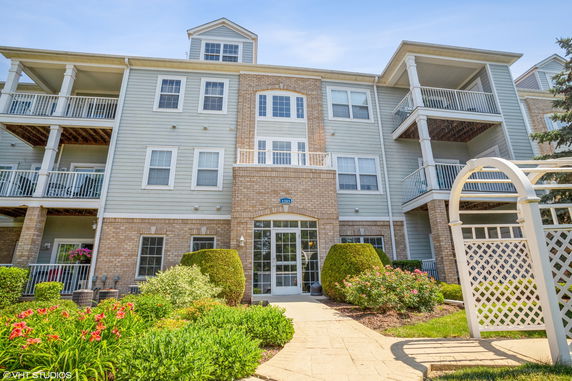 Front view of a multi-story residential building with balconies.