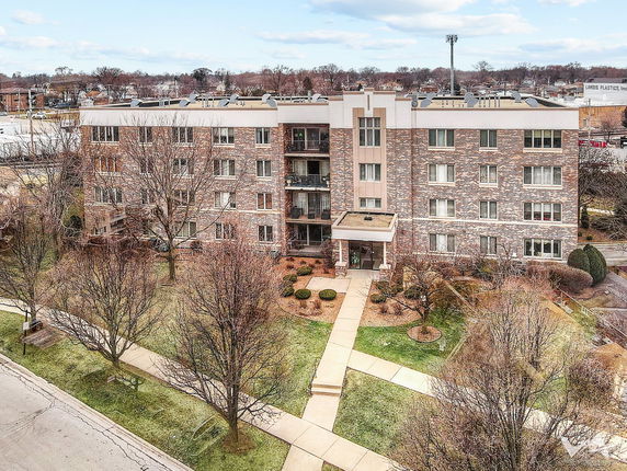 Front view of a multi-story residential building with brick facade.