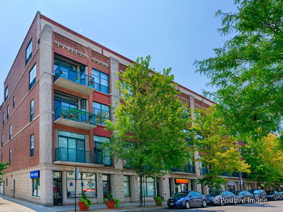 Front view of a multi-story brick building with balconies.