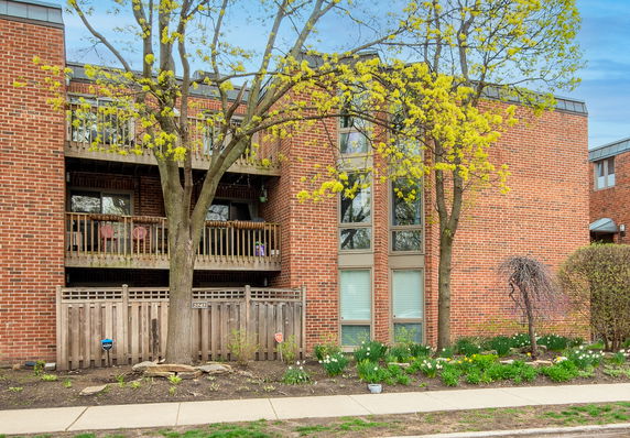 Front view of a multi-story brick building with balconies.