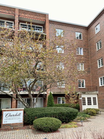Front view of a multi-story brick condominium building.
