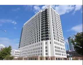 Front view of a tall, multi-story building with a modern design.