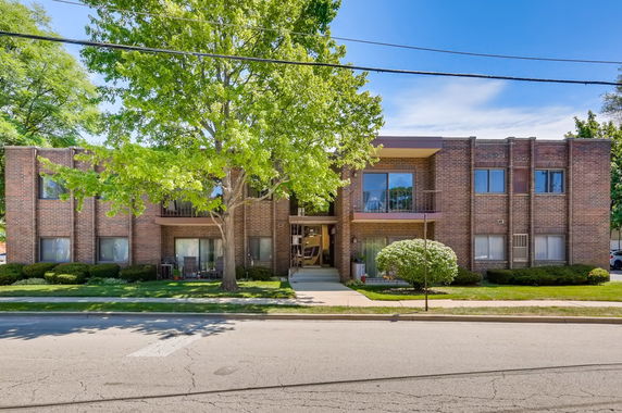 Front view of a two-story brick building with balconies.