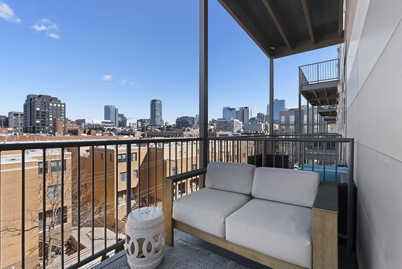 View from a balcony overlooking an urban skyline with multiple buildings.