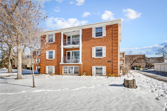 Front view of a three-story brick apartment building.