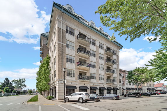 Front view of a multi-story residential building with multiple balconies.