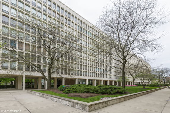 Front view of a multi-story building with large windows.