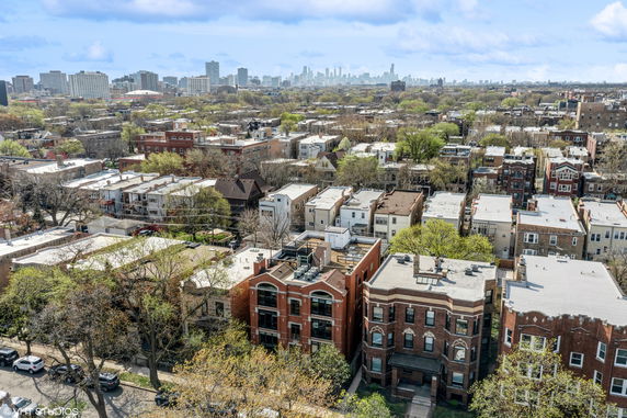 Panoramic view of residential buildings with a city skyline in the background.