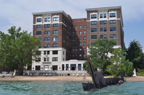 Front view of a multi-story building by the waterfront.