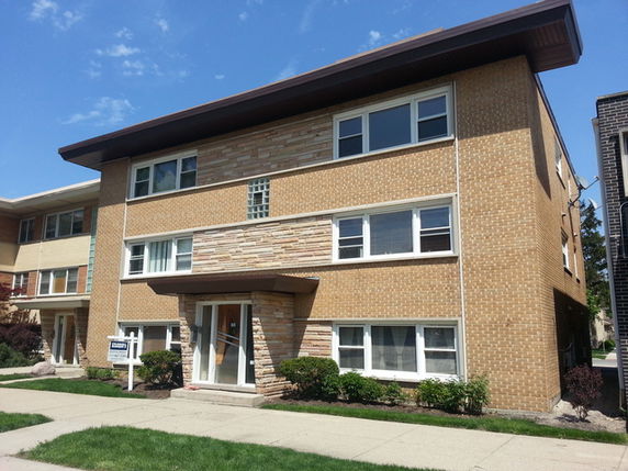 Front view of a three-story brick apartment building.