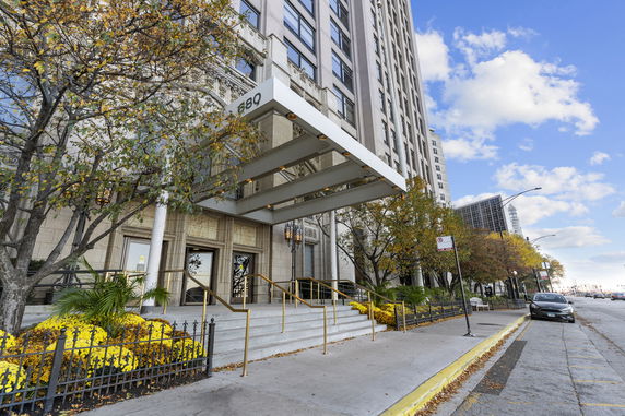 Front view of a tall building with an entrance canopy.