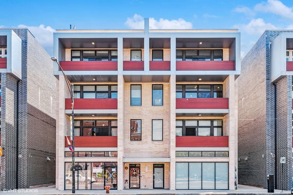 Front view of a multi-story building with red and gray accents.
