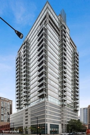 Front view of a modern high-rise building with glass facade.
