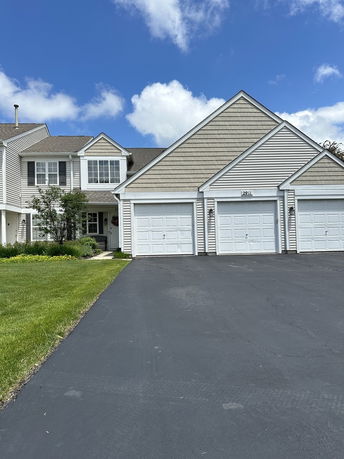 Front view of a two-story house with a three-car garage.