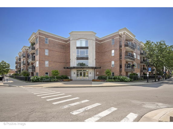 Front view of a multi-story apartment building with brick facade.