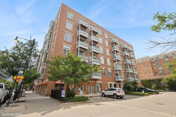 Front view of a multi-story brick building with balconies.