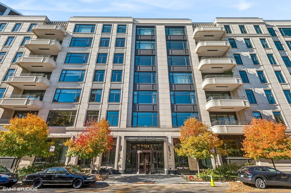 Front view of a multi-story residential building with balconies.