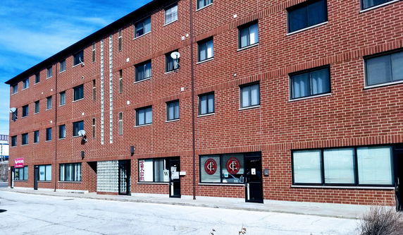 Front view of a multi-story brick building.