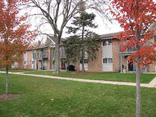 Front view of a two-story apartment building with balconies.