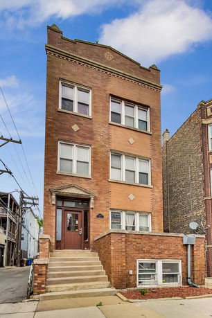 Front view of a three-story brick building.