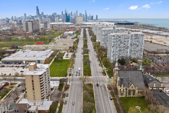 Aerial panoramic view of a cityscape with tall buildings and roads.