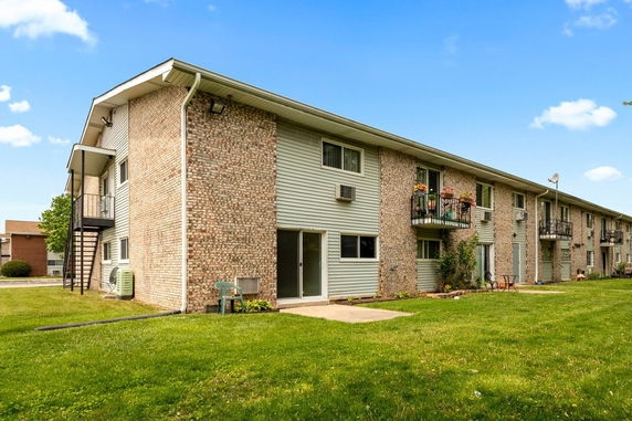 Front view of a multi-story apartment building with balconies.