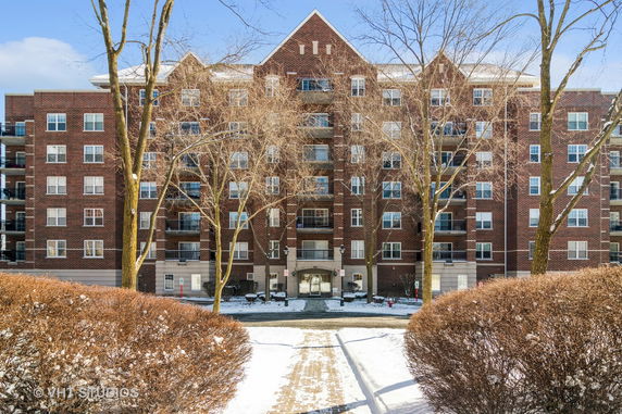 Front view of a multi-story brick apartment building.