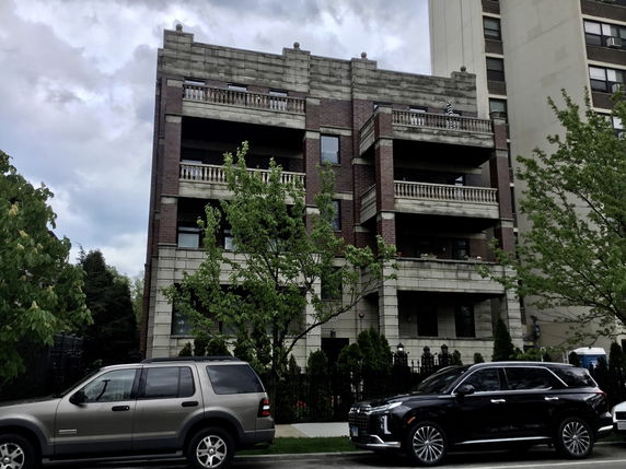 Front view of a multi-story building with balconies.