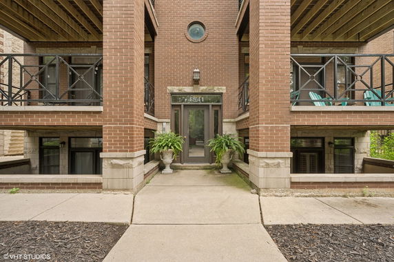 Front view of a multi-story brick building with balconies.