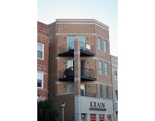 Front view of a multi-story brick building with balconies.