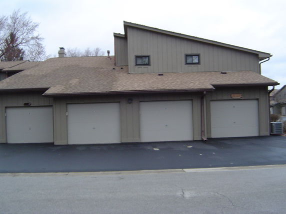 Front view of a multi-car garage attached to a house.