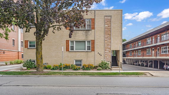 Front view of a beige brick building with visible address number 409.