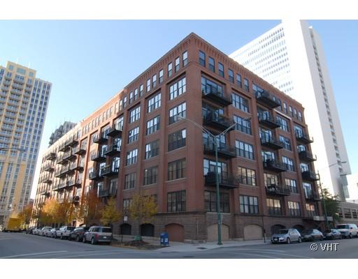 Corner view of a multi-story brick apartment building with balconies.