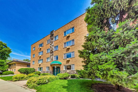 Front view of a multi-story brick condominium building.