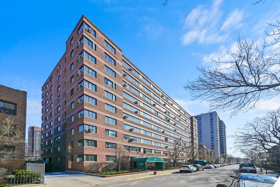 Front view of a multi-story brick apartment building.