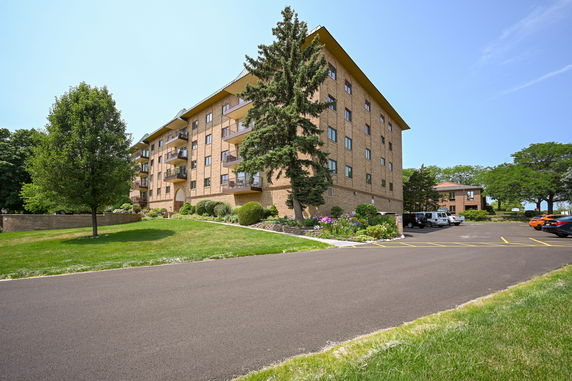 Front view of a multi-story brick building with balconies.
