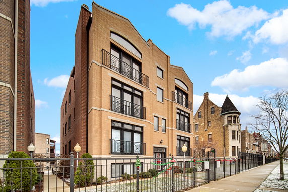 Front view of a multi-story brick apartment building.