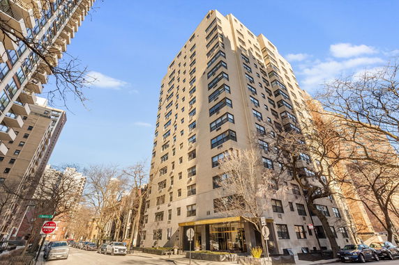 Front view of a multi-story apartment building on a city street.