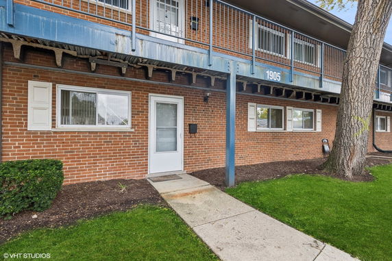 Front view of a brick building with a small entryway.