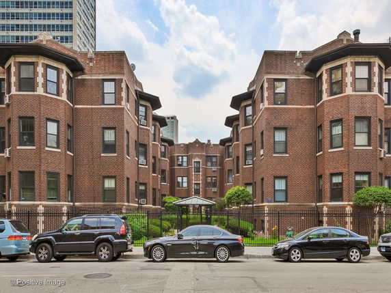 Front view of a three-story brick apartment building.