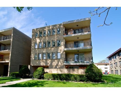 Front view of a multi-story residential building with balconies.