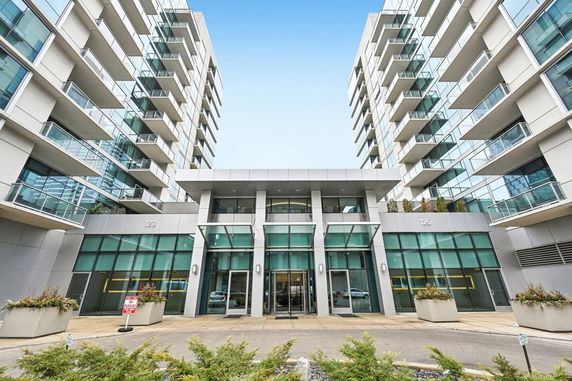 Front view of a modern multi-story apartment building with balconies.