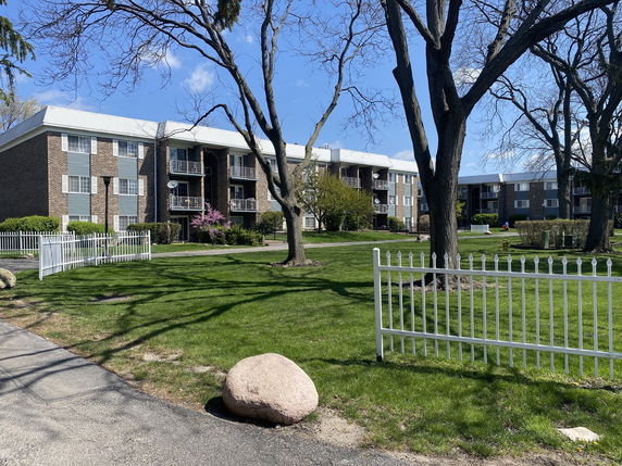 Front view of a multi-story apartment building with balconies.
