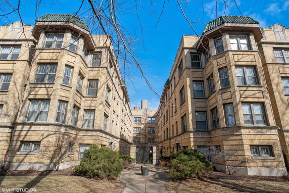 Front view of a multi-story brick apartment building.